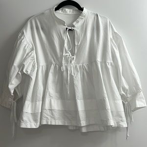 White blouse with ties.